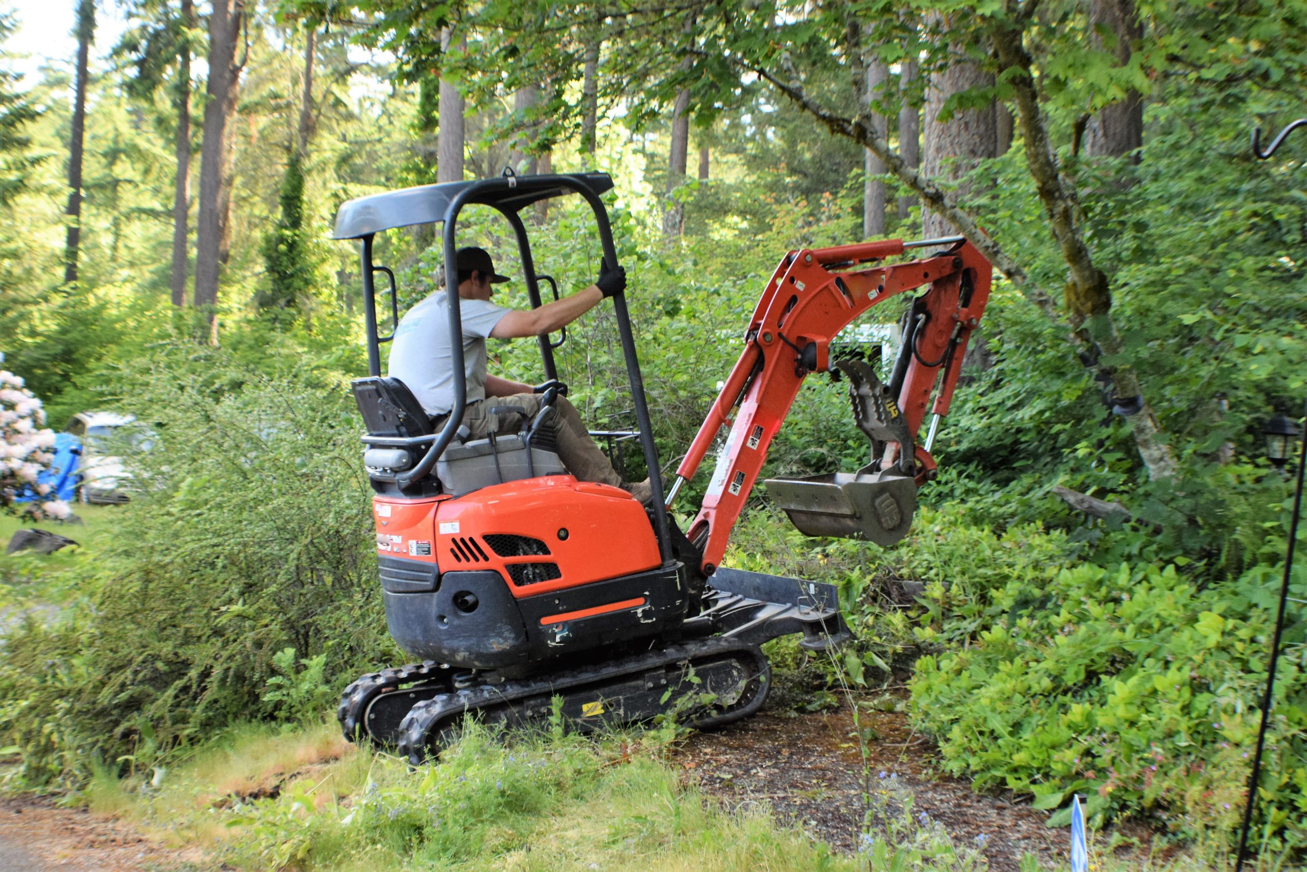 man driving a mini excavator